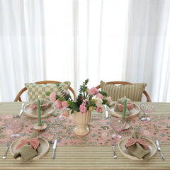 Valley Rose Linen Table Runner on striped tablecloth with rose centrepiece, front view