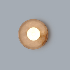 Blot Wall Sconce- combination of translucent stone and brass that creates a warm halo effect.