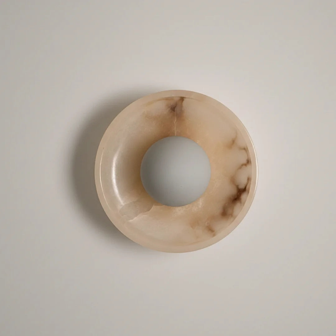 Blot Wall Sconce One, half-round mottled stone dome on brass mount, front view
