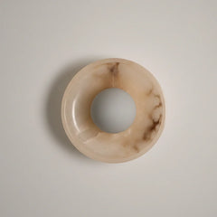 Blot Wall Sconce One, half-round mottled stone dome on brass mount, front view
