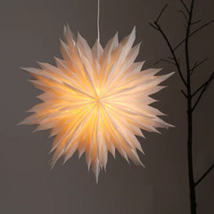 A ceiling-mounted, star-shaped snowflake flower light emitting a warm glow, with a delicate origami lampshade.