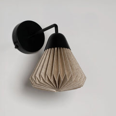 Linen Downlighter Wall Sconce with black fixture and beige pleated shade on a light gray background