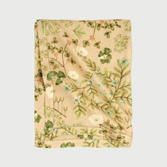 Valley Peach Linen Table Cover folded, showing Himalayan floral print and hem-stitch border