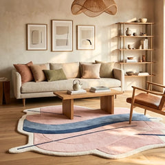 Modern living room with a beige sofa, wooden coffee table, and colorful rug.