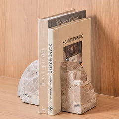 Arcway Bookend made of Capri Beige Marble, side Angle with Larger Books Against Wood Panel