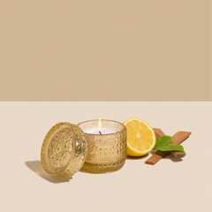 Venetian Bergamot Fragrance with Trinket Jar Candle, gold patterned glass jar and lid with halved lemon and cinnamon sticks