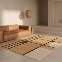 Modern living room with a brown leather sofa and a geometric patterned rug.