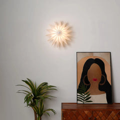 Daisy Wall light in layered petals unique design with ambient lighting mounted on a wall next to other home decor