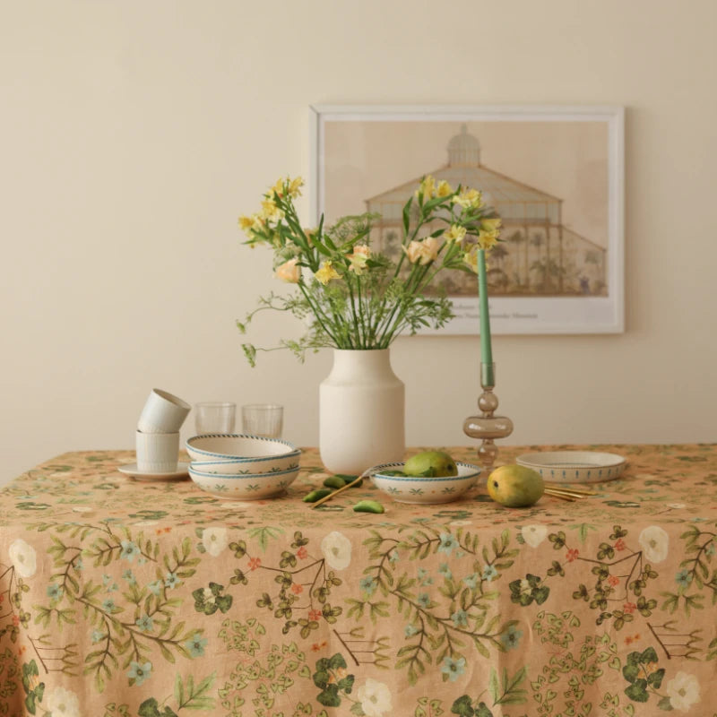 Valley Peach Linen Table Cover styled with vase of yellow flowers and ceramic bowls