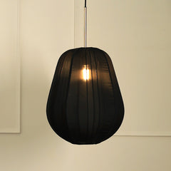 A black georgette pendant light hanging in a room, diffusing light and creating a warm glow on a white background