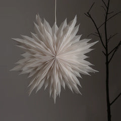 Star-shaped snowflake flower light hanging from a ceiling