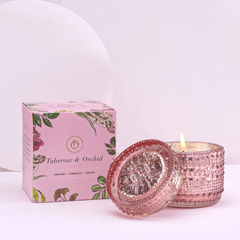 Tuberose & Orchid Fragrance Trinket glass candle jar with lid and its matching floral-patterned box, labeled 'Tuberose & Orchid' on a clean white background.  