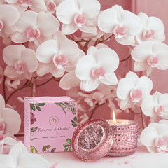 Tuberose & Orchid Fragrance Trinket Jar Candle, lit jar and box surrounded by white orchids
