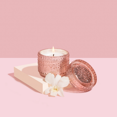 Tuberose & Orchid Fragrance Trinket Jar Candle, lit pink glass jar on cream tray with white orchid and lid
