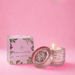 Tuberose & Orchid Fragrance Trinket Jar Candle, pink glass jar with lid and box on a bright pink backdrop