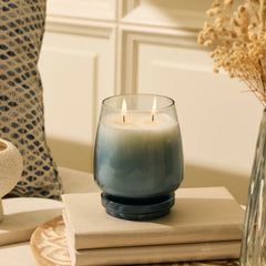 Cosmic Set - Lid Jar Candle (M) & Diffuser - Dusk - Balmy Bergamot - Set of 2, lit two-wick smoky blue candle on books
