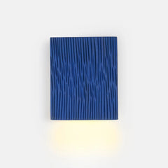 Blue textured wall light fixture on a white background