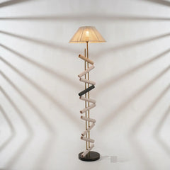 Spiral design floor lamp with a beige shade on a white background