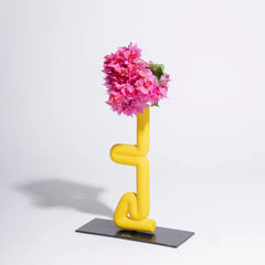 Yellow abstract Sirsasana Vase with pink flowers on a white background