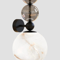 Close-up of smoked glass globe and brushed steel arm on Alabaster wall sconce