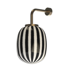 Wall-mounted light fixture with black and white striped design and brass mount