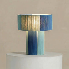 Decorative Table lamp with a blue and green striped design on a beige background