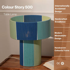 Colorful table lamp with text highlighting design and craftsmanship on a wooden surface.