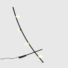 Comet Floor Lamp side view showing arched frame silhouette
