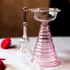 Glass Tall Diya & Ringing Bell Pink, ribbed pink glass diya with clear bell and red roses, close-up