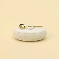 Twin Marble Server closed with gold spoon resting on lid, white marble, front view on plain background