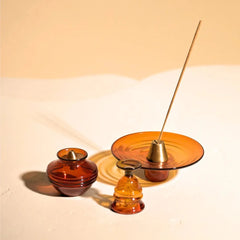 Kalash Oil Lamp + Incense Holder + Small Bell, amber borosilicate glass pieces with incense stick, close-up