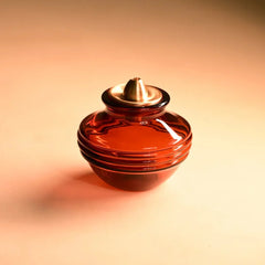 Kalash Oil Lamp + Small Ringing Bell, amber glass kalash lamp with gold-tone wick cap, front view
