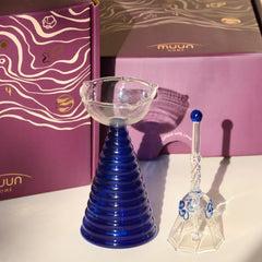 Glass Tall Diya & Ringing Bell Blue, ribbed cobalt blue borosilicate diya and glass bell beside purple gift box