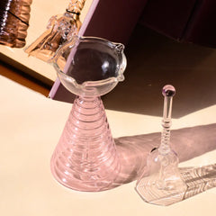 Glass Diya & Ringing Bell Pink, diya and bell with pink bead top in sunlight, angled top view