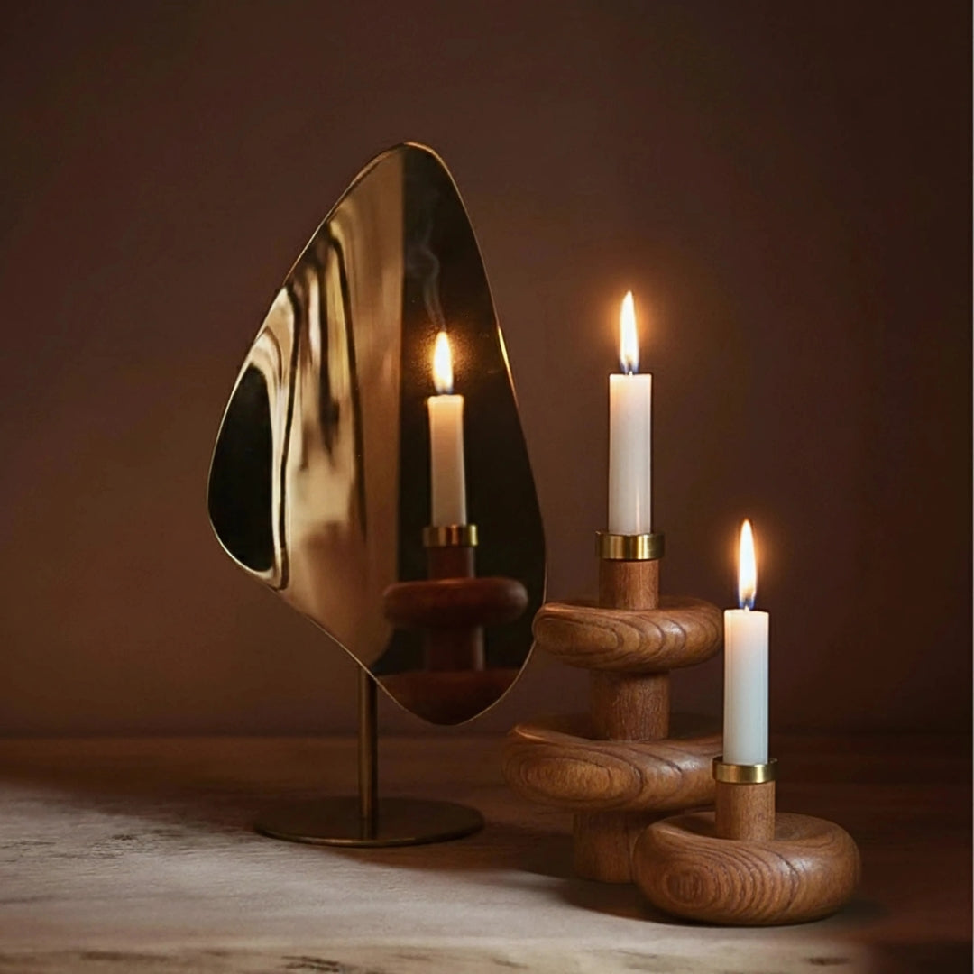 Decorative Warm Wave Candle Holder with a reflective gold mirror and wooden base against a dark background