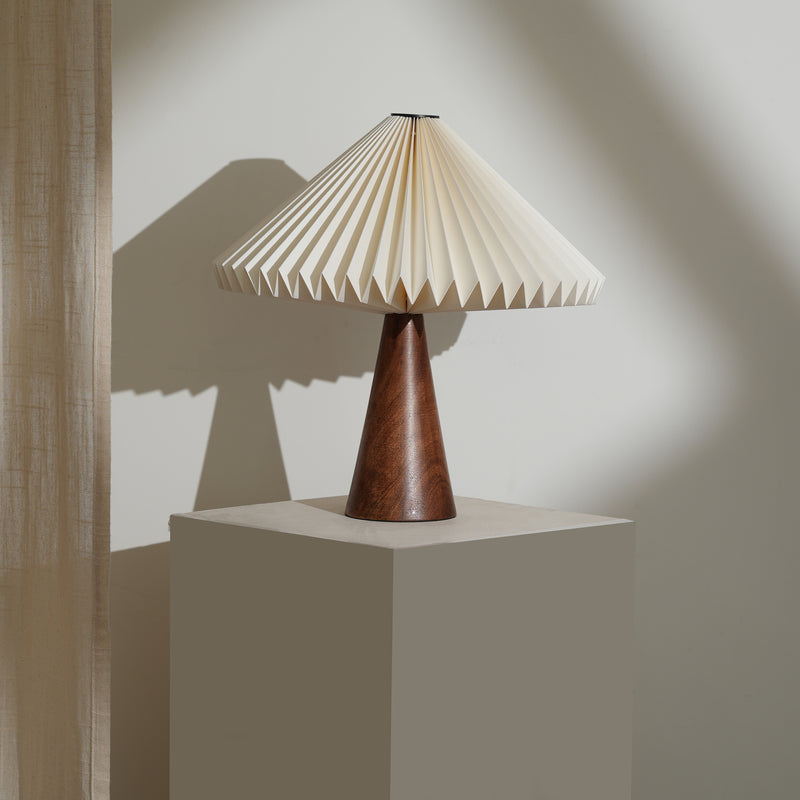 Ballet Table Lamp with pleated beige shade and wooden base on a neutral background