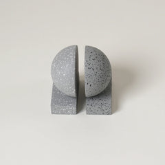 Speckled gray Monolith Concrete Bookends on a light beige background