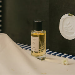 A clear glass bottle of 'Zeph' room Perfume with Diffusion Stone