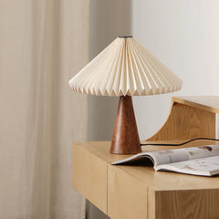 Ballet Table lamp with pleated beige shade on a wooden surface for table/desk
