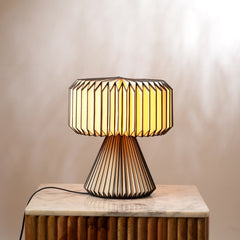 Modern origami paper table lamp with geometric design on a wooden surface