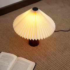 Ballet Table Lamp with warm ambient glow on a textured surface for Reading