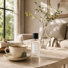Eden - Uplifting & Refreshing Perfume Room Spray - Glass Bottle on Stone Table with Teacup in Sunlit Living Room, Lifestyle View