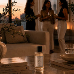 Zeph - Bold & Sophisticated Perfume Room Spray - Glass Bottle on Coffee Table in Evening Living Room with Guests, Lifestyle View