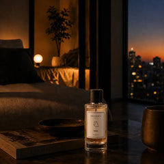 Vibe - Sensual & Moody Perfume Room Spray - Glass Bottle on Bedside Table at Night with City Skyline View, Lifestyle Shot
