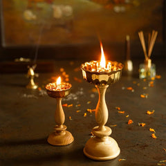Dipam - White Oak, lit big and small brass oil lamps on white oak stands in festive setting