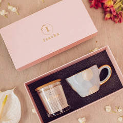 Gift box set with glass candle jar and light blue color ceramic cup with gold finish.