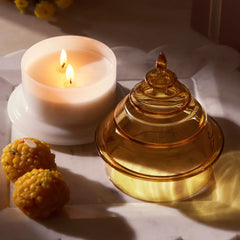 Candle with a decorative kanak yellow glass top