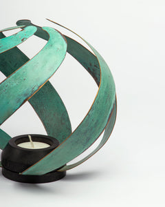 Unique teal color tealight holder inspired by patina brass fire with a dark finish wood base.