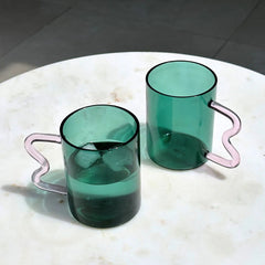 Two Swirl Glass Cups with unique design and pink handle