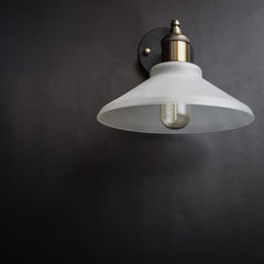 Nordic conical glass wall sconce frosted shade with golden interior on grey wall